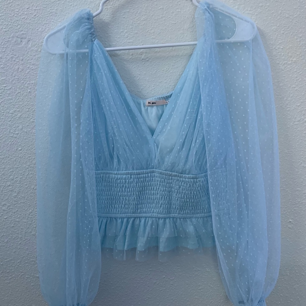 Francesca’s blue puffy sleeved shirt